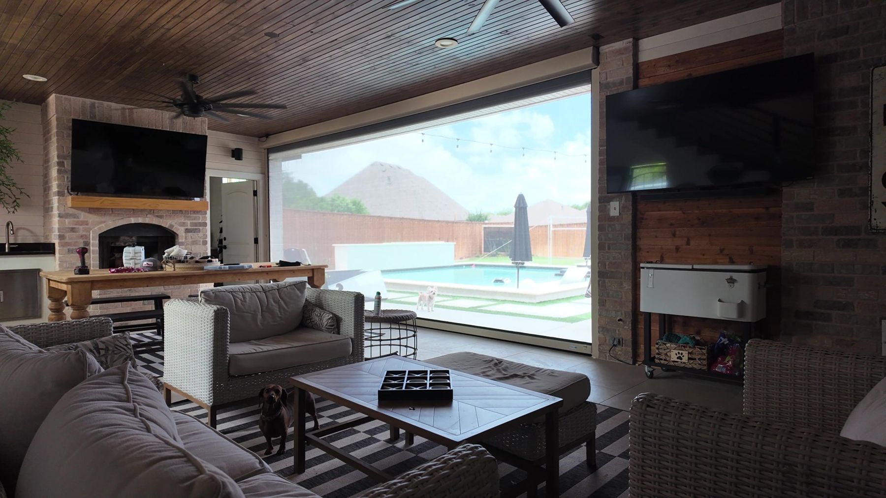 Screened outdoor living room with a pool view