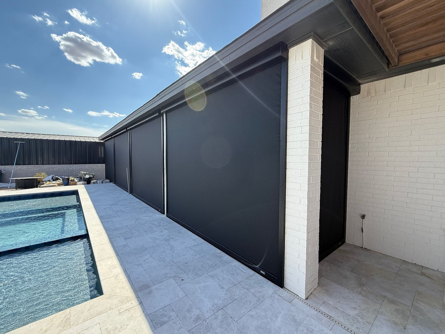 Black screens along a new pool deck